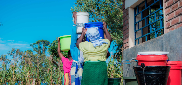 Women carrying water buckets on their heads 