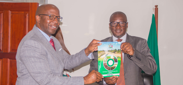 Hon. Eng. Collins Nzovu, MP, Minister for Green Economy and Climate Change (rights) and Dr Douty Chibamba, Permanent Secretary in the Ministry showcase the National Adaptation Plan for Zambia during its launch