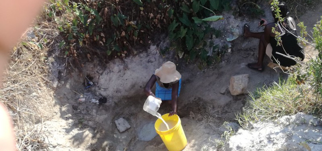 Women drawing water from a well