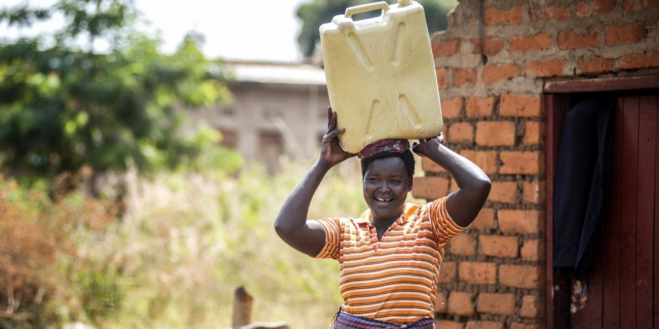 Alur Florence fetches water while her husband does other chores at home